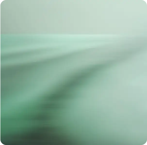 Abstract blurred gradient background in soft green and teal tones.